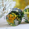 Resin ear plugs made with orange lichen and green moss