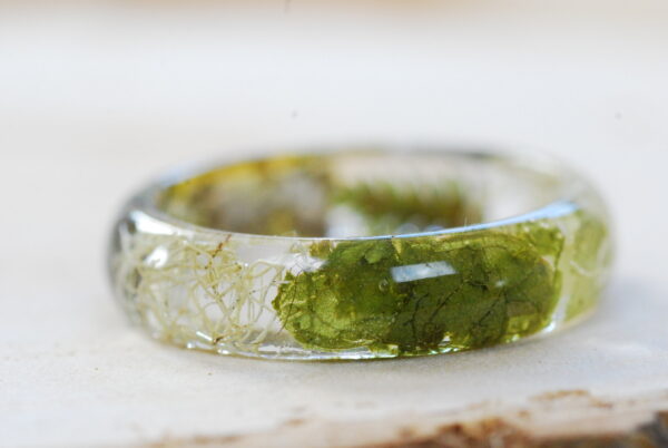 side look of Orange lichen and ferns natural ring with leaves and beard lichen