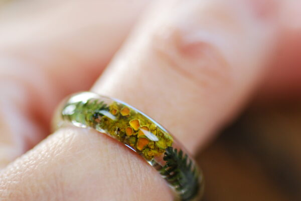 orange lichen fern and leafs ring on finger