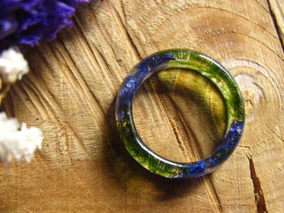 top view of green moss and blue cornflower ring