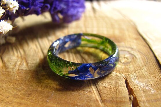 Fairy blue pressed flowers with green moss fairy ring