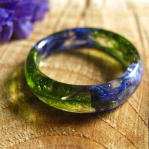 Fairy blue pressed flowers with green moss in crystal resin ring