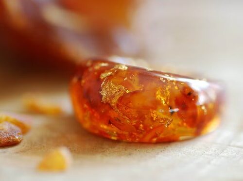 Statement and bold amber baltic ring with real 24k gold flakes in orange dyed resin.