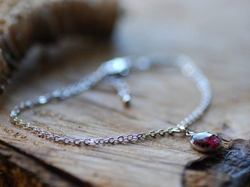 Silver bracelet with garnet charm