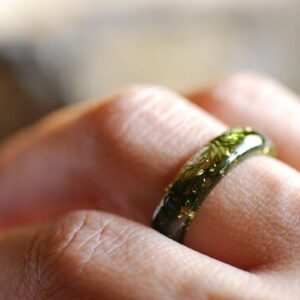 finger worn resin ring with moss and a bit of gold