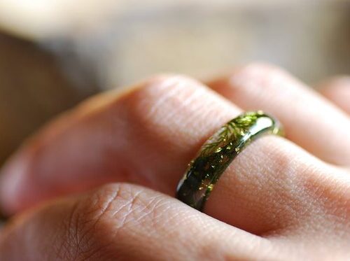 finger worn resin ring with moss and a bit of gold