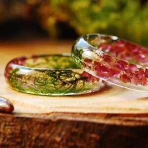 two resin rings made of garnet stones green moss and gold flakes