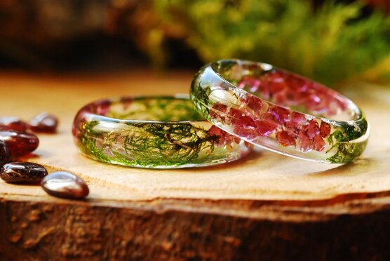 two resin rings made of garnet stones green moss and gold flakes