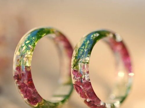 pair of red garnet stones green forest moss resin rings