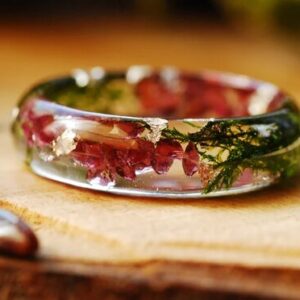 garnet moss and gold flakes resin ring close up