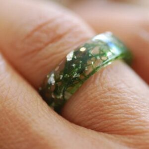 Flat ring band with real moss and sterling silver flakes on finger