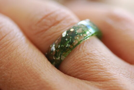 Flat ring band with real moss and sterling silver flakes on finger