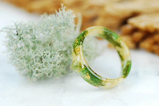 Round peridot cabochon set in Resin ring made with jasmine flowers , real green moss, green skeleton leaves and gold flakes