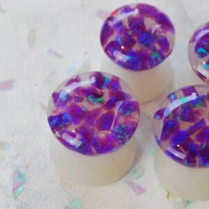Purple opal iridescent ear gauges made of white resin and lab opal on top 
