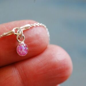 little iridescent pink opal charm close up