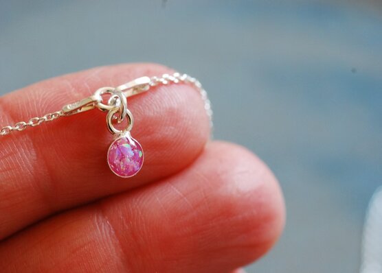 little iridescent pink opal charm close up