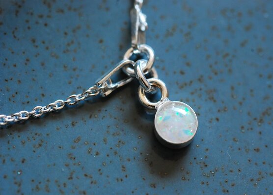 Silver bracelet with lab white opal charm