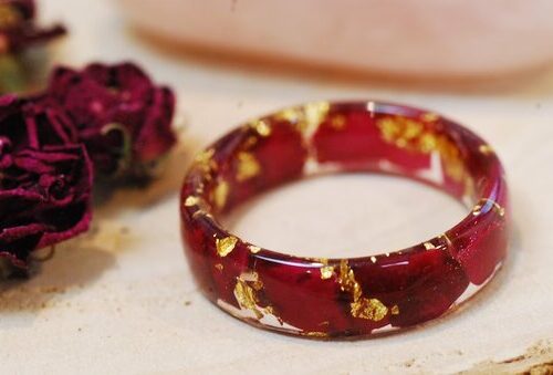 close up of ring made with red rose petals and pure gold