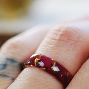 red rose petals and pure fold flakes ring on finger