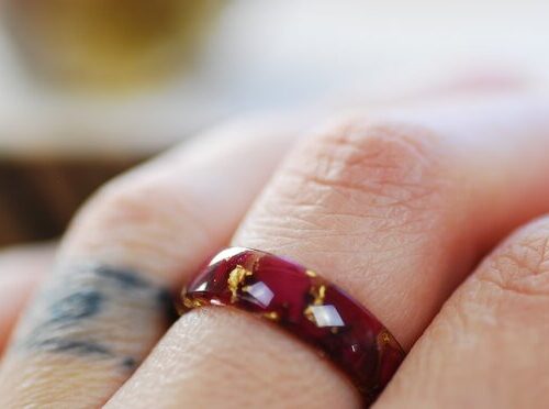 red rose petals and pure fold flakes ring on finger