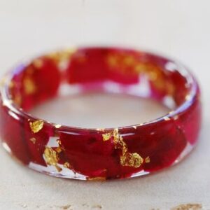 close up of ring made with red rose petals and pure gold
