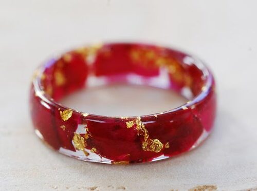 close up of ring made with red rose petals and pure gold