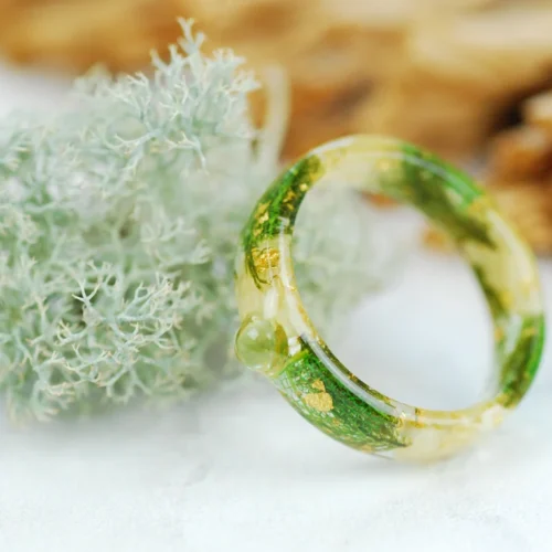 Round peridot cabochon set in Resin ring made with jasmine flowers , real green moss, green skeleton leaves and gold flakes