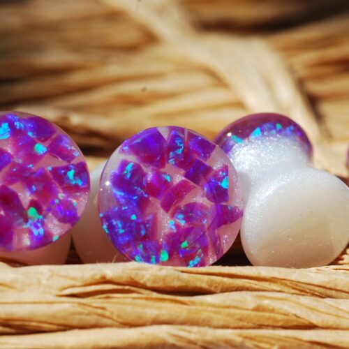 Purple opal iridescent ear gauges made of white resin and lab opal on top 