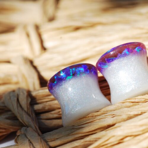 Purple opal iridescent ear gauges made of white resin and lab opal on top 
