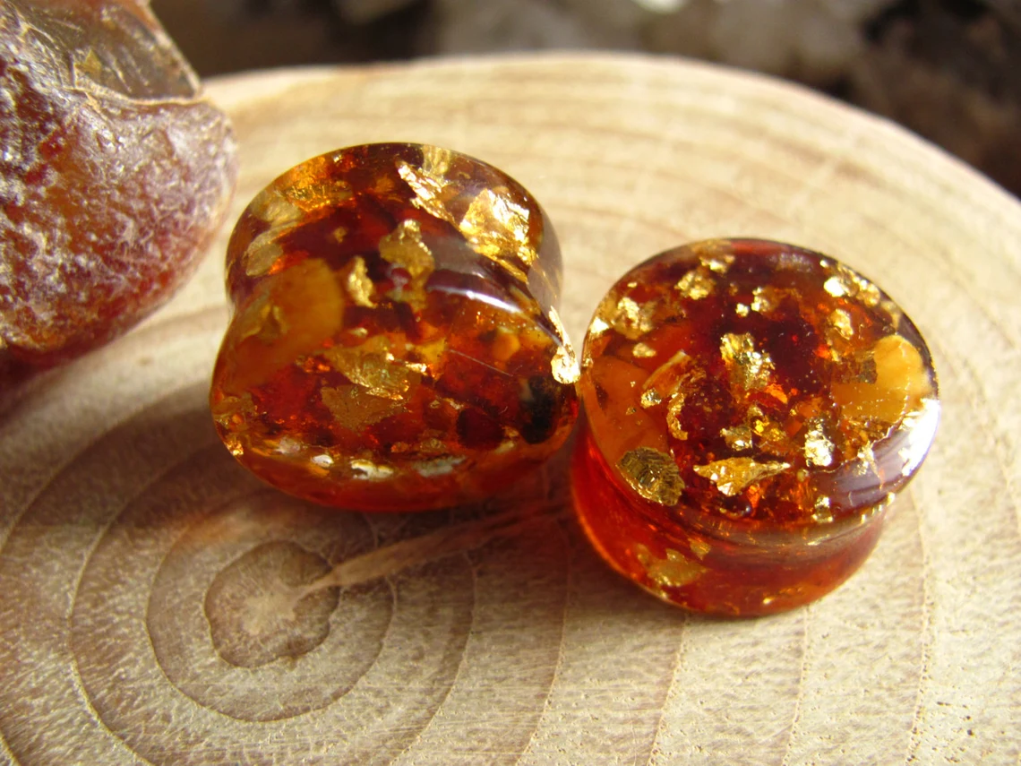 Those ear plugs are made of resin with real Baltic amber and 24k gold