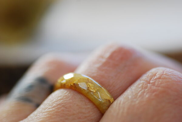 gold classic resin ring on finger