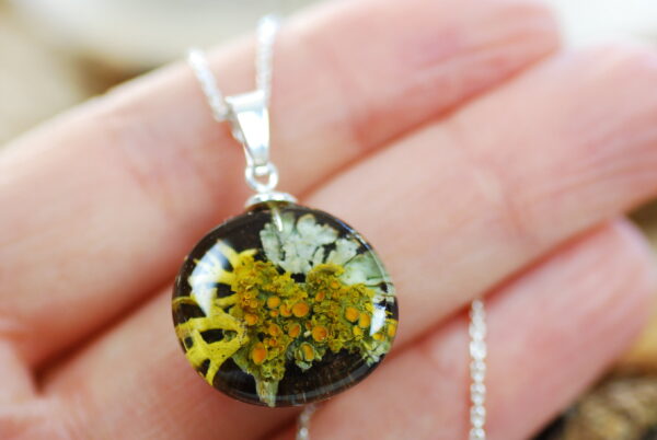 hand holding fairy forest lichen necklace