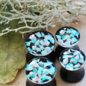 four white opal ear plugs together