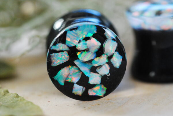 iridescent white opal gauges on dark background