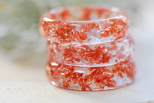 Clear faceted resin ring with copper flakes