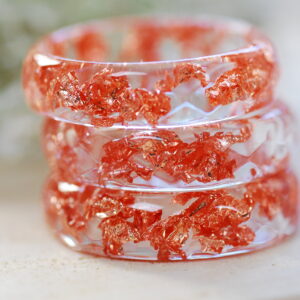 Clear faceted resin ring with copper flakes