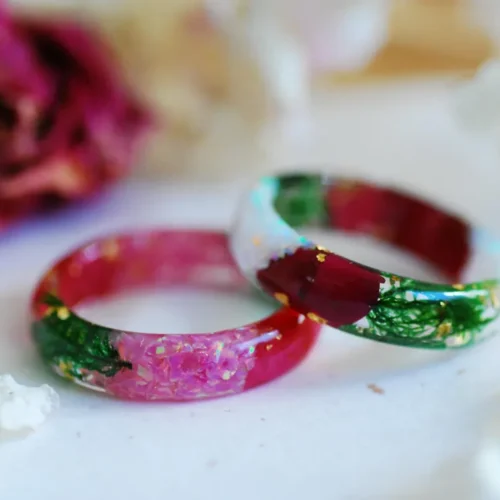 white opal and pink opal rings with rose petals and moss