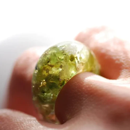 green olivine peridot and yellow citrin and gold ring on finger
