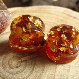 Those ear plugs are made of resin with real Baltic amber and 24k gold