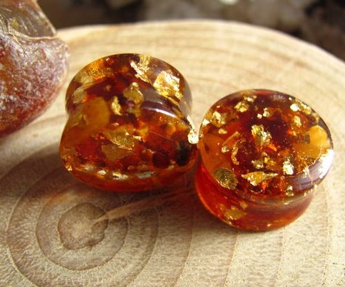 Those ear plugs are made of resin with real Baltic amber and 24k gold