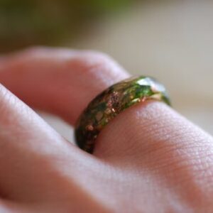 nature ring with green moss and copper on finger