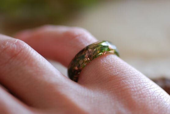 nature ring with green moss and copper on finger