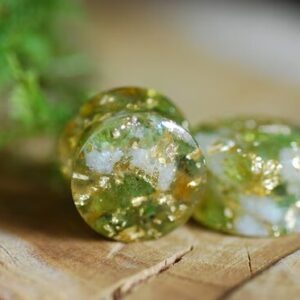 Double flared Clear resin ear gauges with peridot and citrine gemstones inside mixed with 24k gold flakes