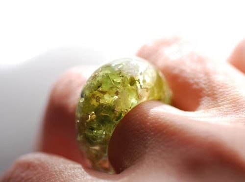 green olivine peridot and yellow citrin and gold ring on finger