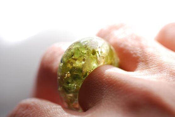 green olivine peridot and yellow citrin and gold ring on finger