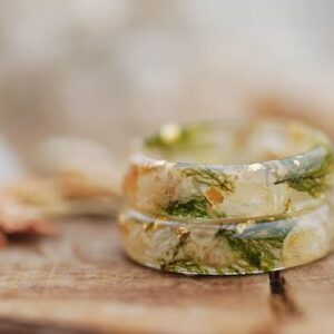 Pressed flower ring made with jasmine and baby's breath flowers , green moss and gold flakes set in clear resin