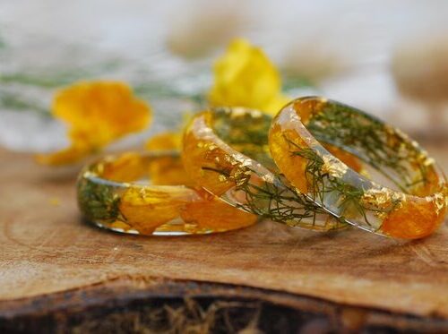 happy yellow buttercup and green ring with moss and flowers