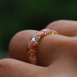 yellow gold and orange copper ring on finger