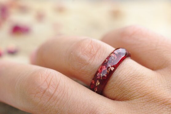 red and gold flakes ring on finger