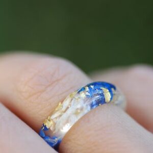 blue lapis white flowers and gold flakes ring on finger